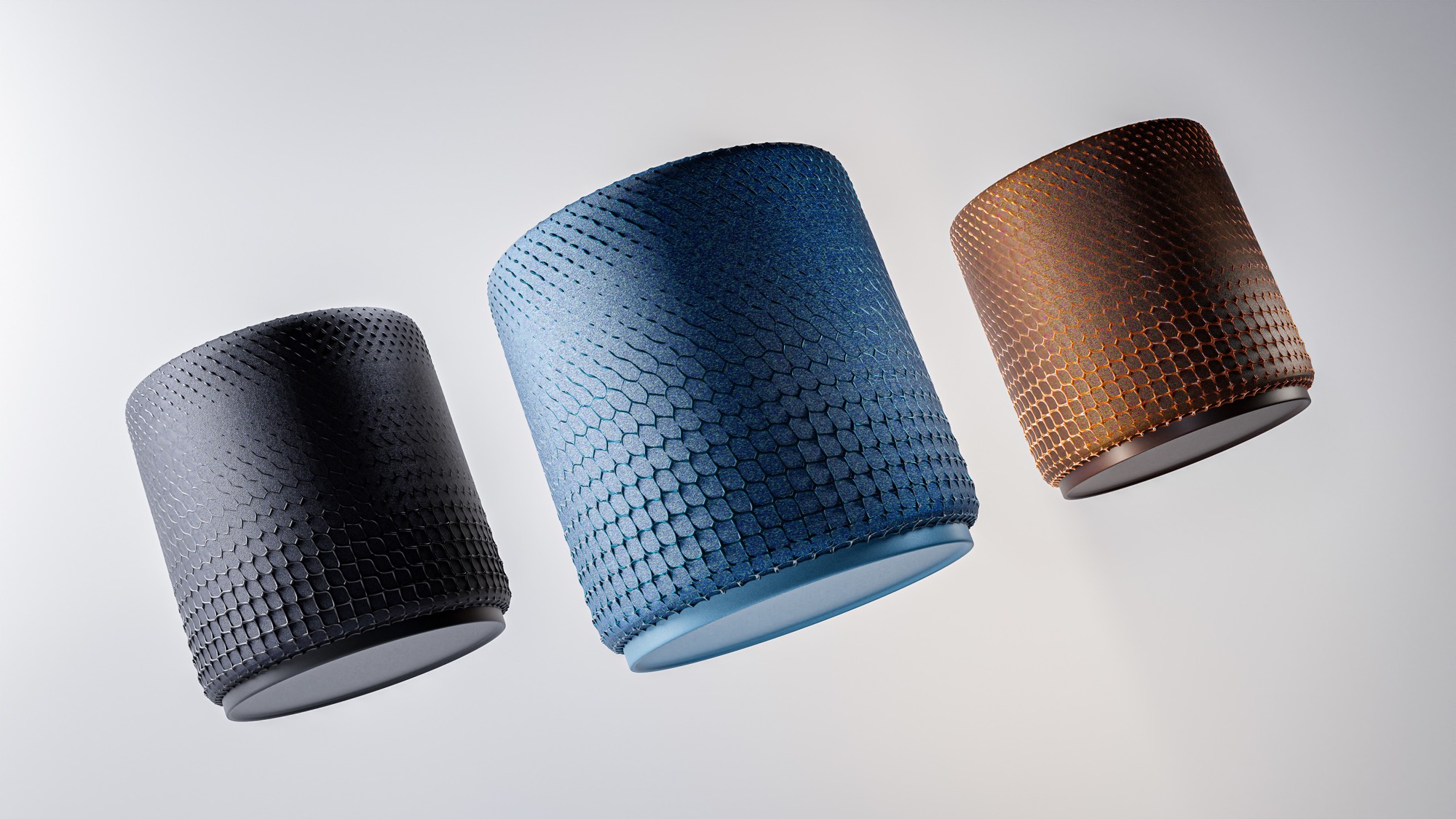 Three ARC speakers floating at an angle — charcoal, blue and bronze — each with a different parametric scale pattern across its textile surface