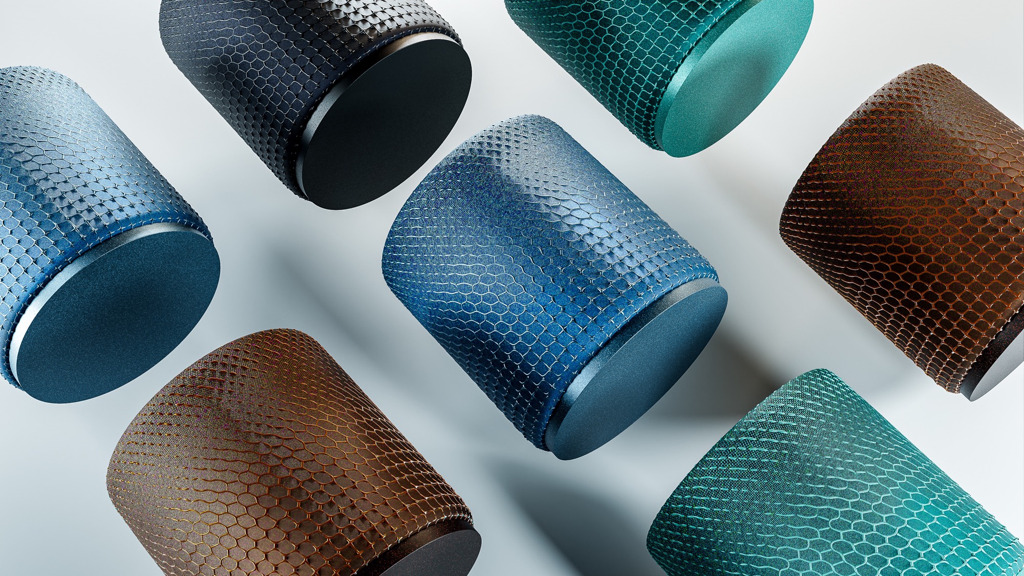 Eight ARC speakers arranged in an overhead grid on white, in blue, black, teal and brown, showing the range of parametric patterns and densities