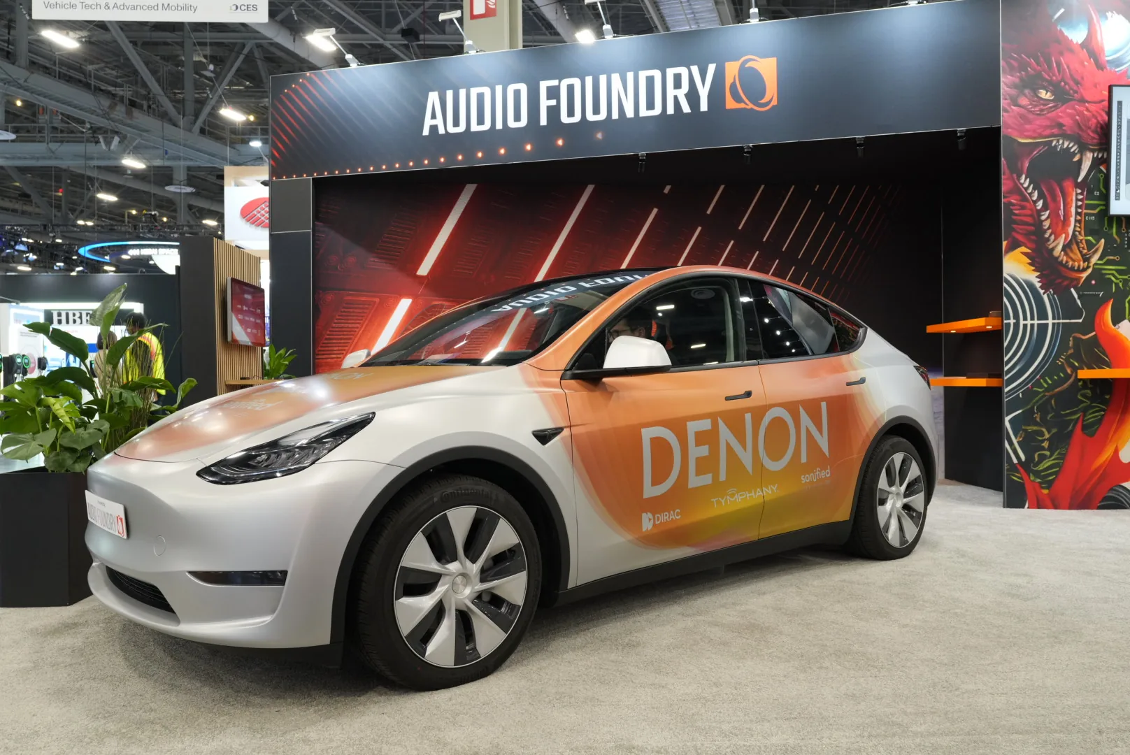 Audio Foundry booth at CES 2025 — Denon-wrapped Tesla Model Y on the stand