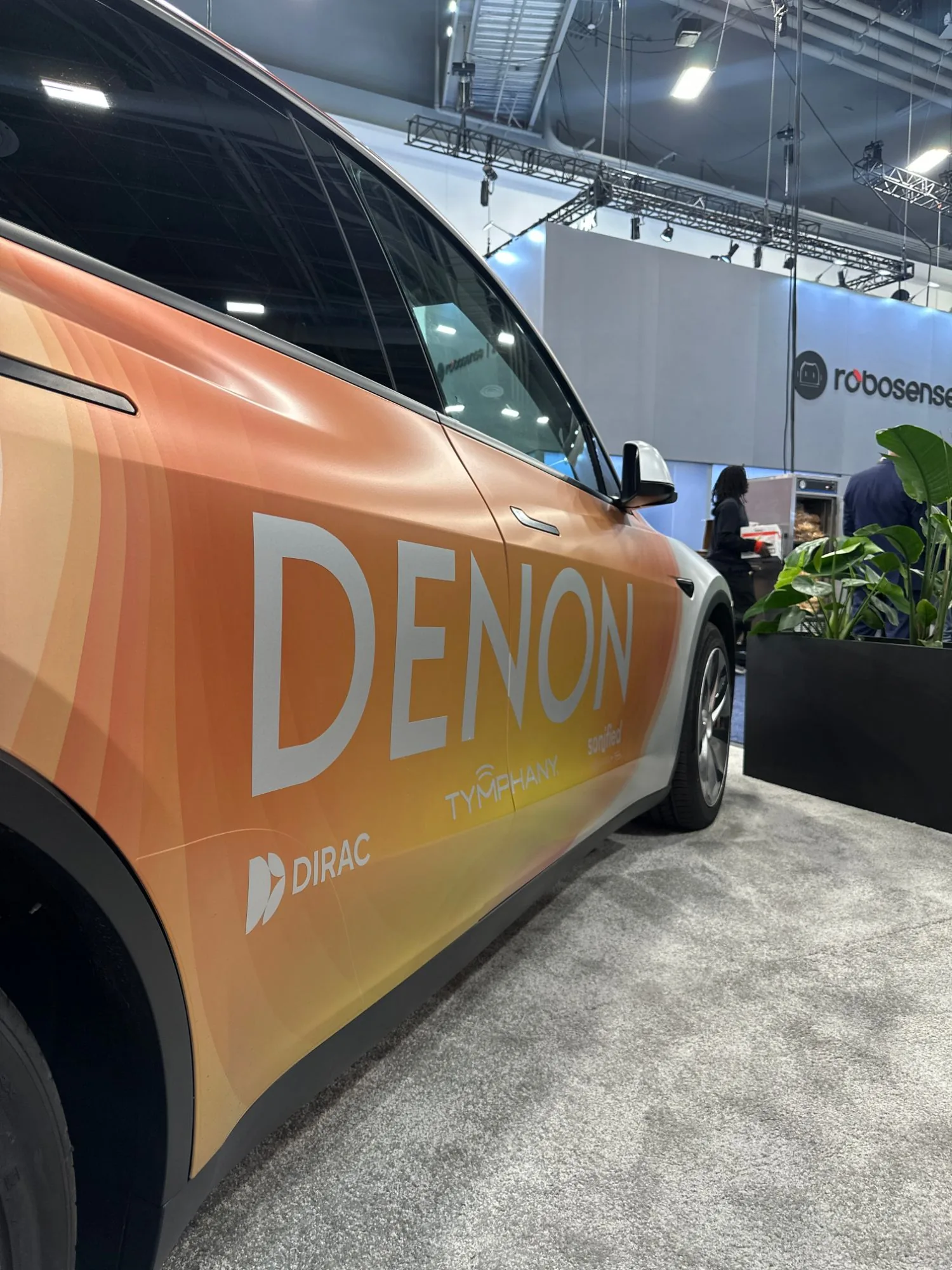 Denon livery close-up — gradient wrap with Dirac, Tymphany and Sonified partner marks